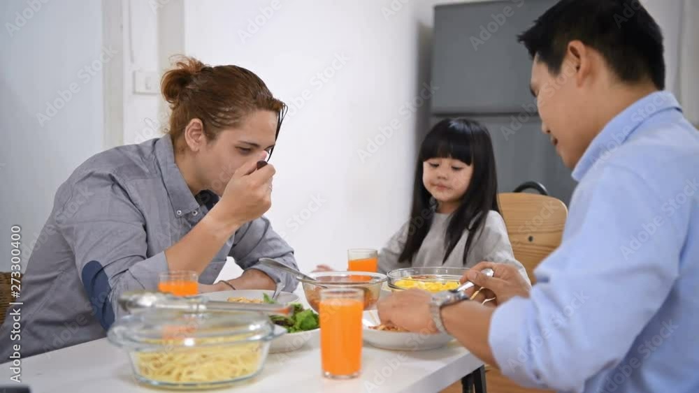 Family concept. The girl is eating food with her family. Family concept. The girl is eating food with her family.