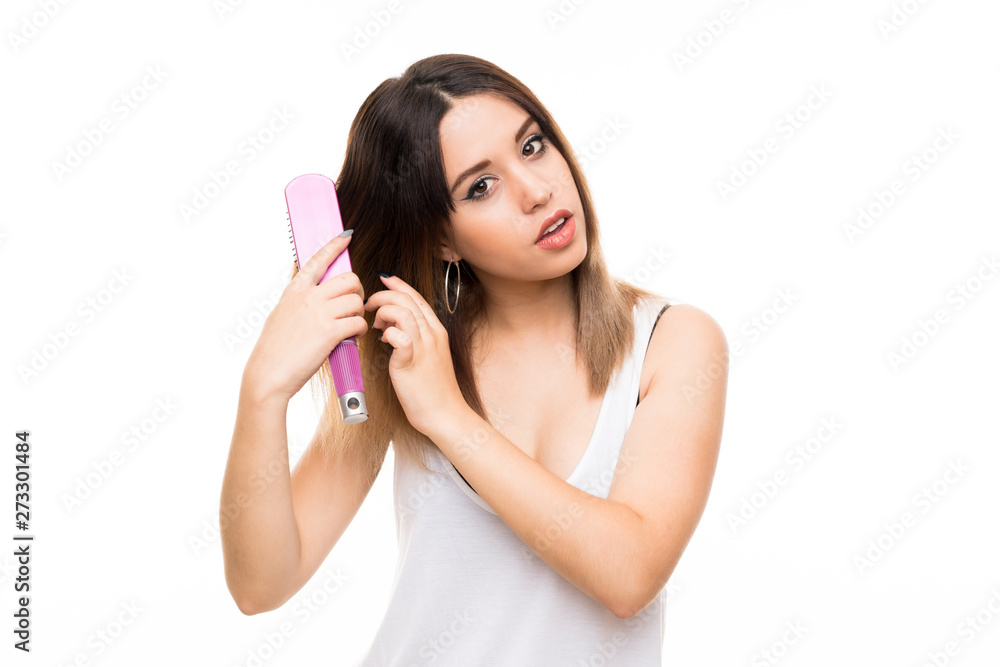 Young woman over isolated white background with hair comb Young woman over isolated white background with hair comb