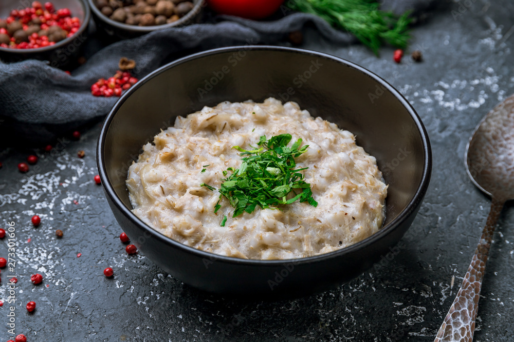 Pearl barley on black bowl