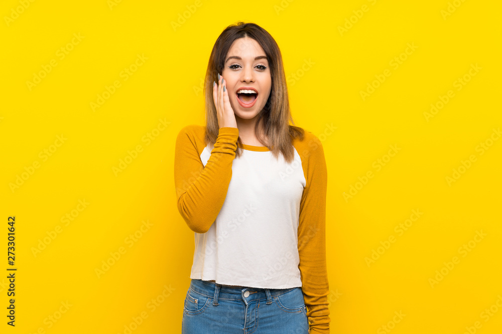 Pretty young woman over isolated yellow wall with surprise and shocked facial expression Pretty young woman over isolated yellow wall with surprise and shocked facial expression