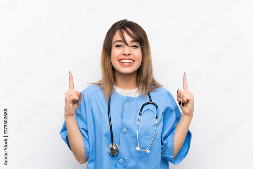 Young nurse woman over white wall pointing up a great idea Young nurse woman over white wall pointing up a great idea