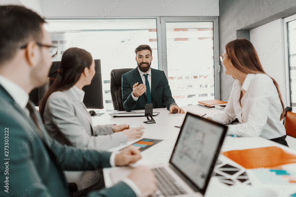 Successful team having meeting at boardroom. Selective focus on CEO talking to employee. Successful team having meeting at boardroom. Selective focus on CEO talking to employee.