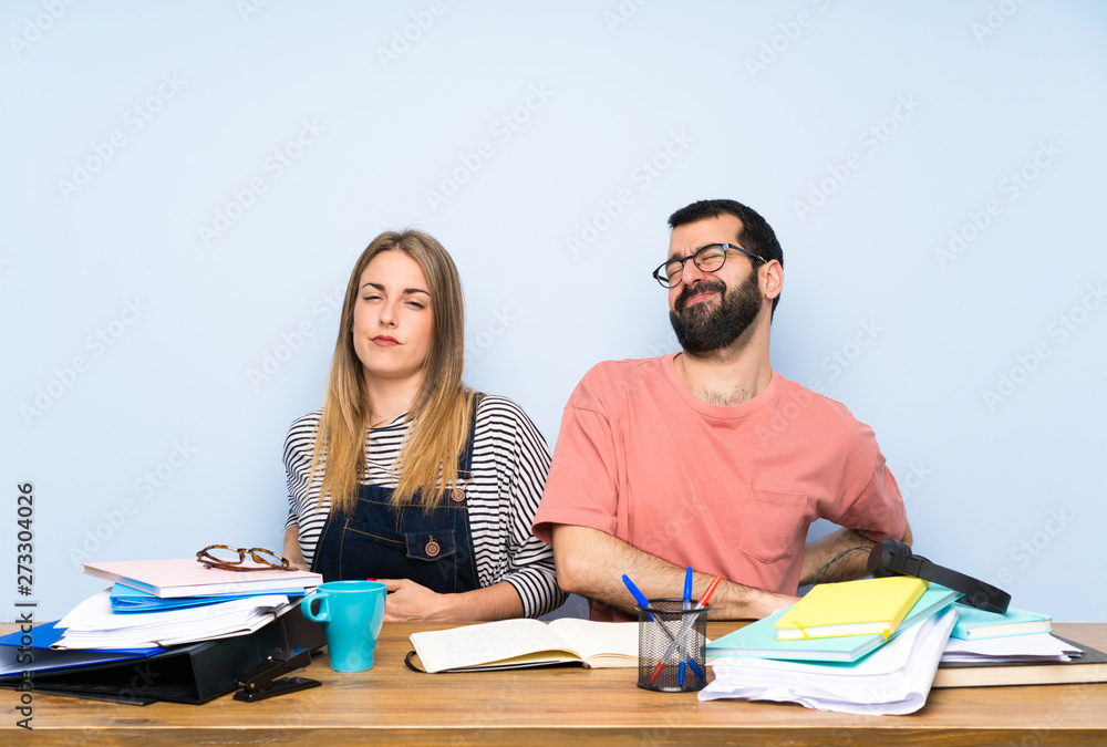 Students with many books suffering from backache for having made an effort Students with many books suffering from backache for having made an effort