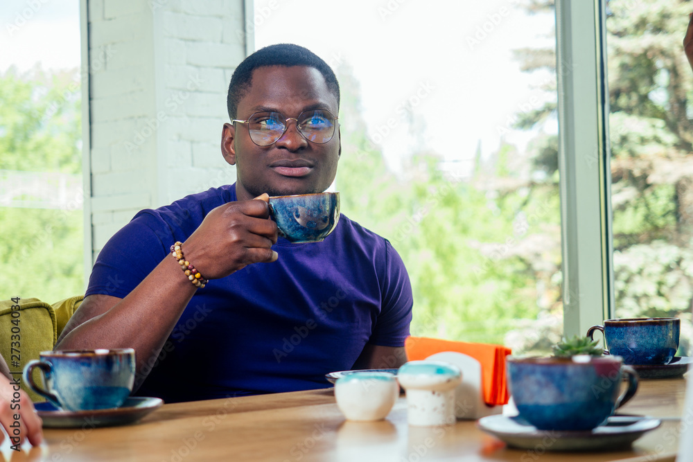 Portrait of a smiling businessman with laptop at cafe. Portrait of a smiling businessman with laptop at cafe.