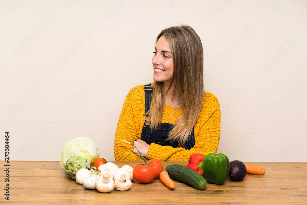 Fototapeta premium Woman with lots of vegetables laughing