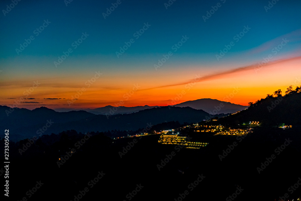 Fototapeta premium A Tranquil Scenic Landscape of Beautiful Sunset with the Resort Camping at Mon Jam, Chiang Mai, Thailand.