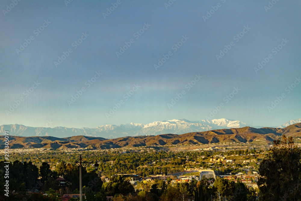 Snow capped mountains above the hills of Anaheim California.