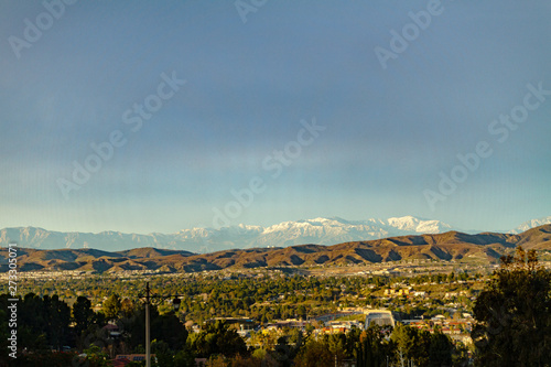 Snow capped mountains above the hills of Anaheim California.