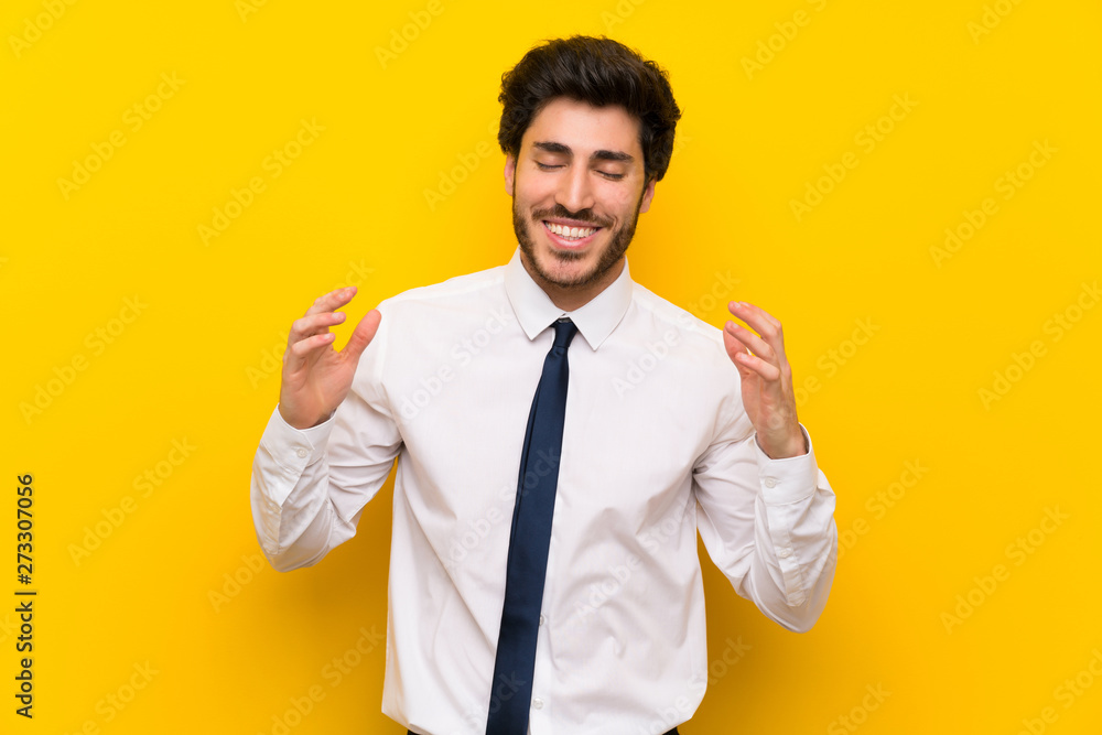 Businessman on isolated yellow background laughing Businessman on isolated yellow background laughing
