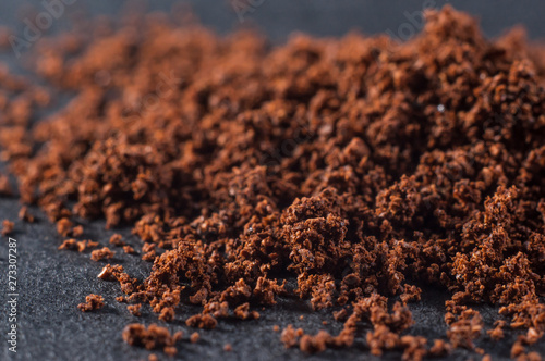 Fresh ground brewed coffee on a dark background, close-up