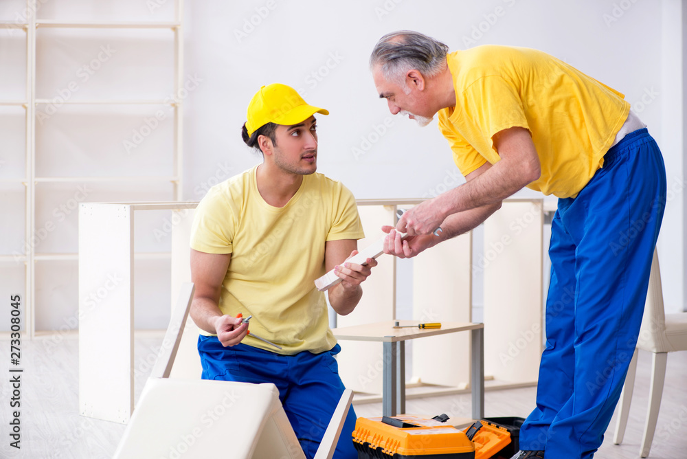Two contractors carpenters working indoors Two contractors carpenters working indoors