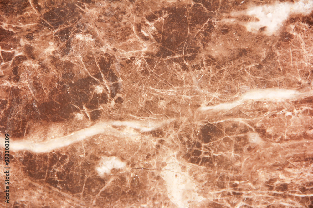 marble brown decorative wall with patterns, stains and cracks