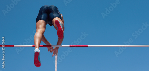 Athlete pole vault with a blue sky