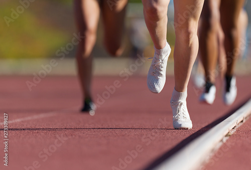 Group of athletes sprinters run speed on track of stadium