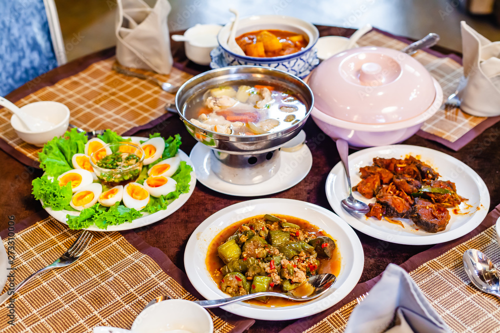 Group of Foods, Boiled Eggs with Fish Sauce, Fried Spicy Fish and Spicy Stir Fried Slice Eggplant and Pork Boiled Soup a Healthy Food Thai Food on Thai Decorate Table. Group of Foods, Boiled Eggs with Fish Sauce, Fried Spicy Fish and Spicy Stir Fried Slice Eggplant and Pork Boiled Soup a Healthy Food Thai Food on Thai Decorate Table.
