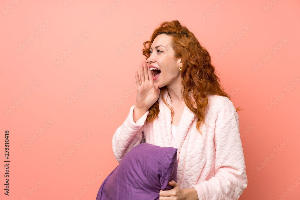 Redhead woman in dressing gown shouting with mouth wide open Redhead woman in dressing gown shouting with mouth wide open