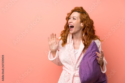 Redhead woman in dressing gown with surprise facial expression