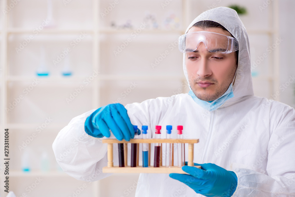 Young male chemist working in the lab Young male chemist working in the lab