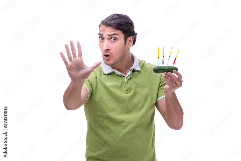 Young man in GMO fruits and vegetables concept Young man in GMO fruits and vegetables concept