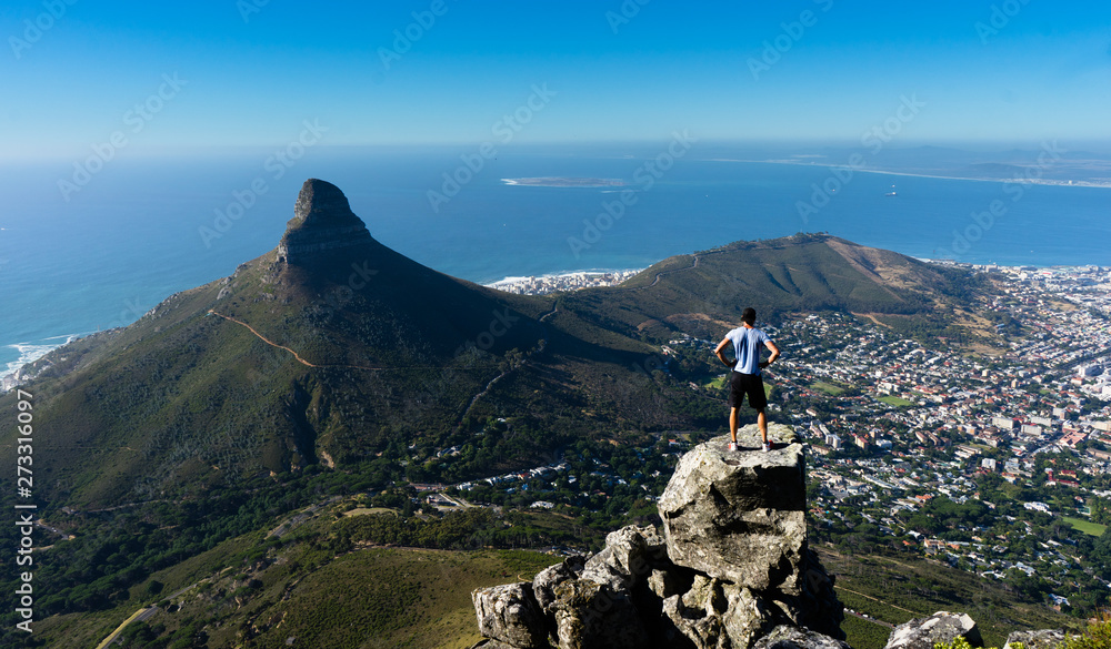 A hiker looking out over Cape Town from the top of Table Mountain