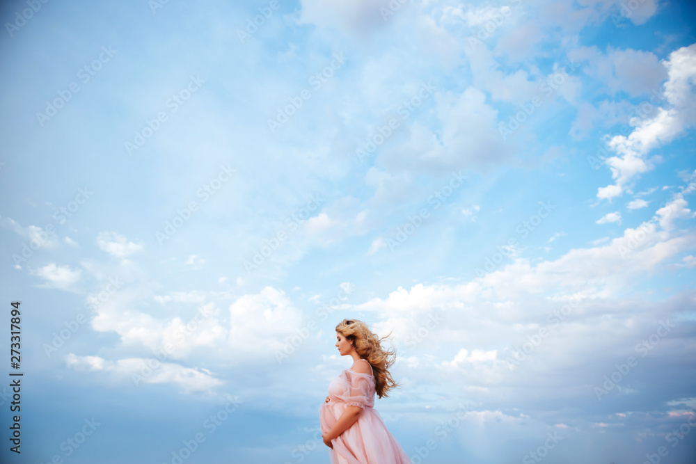 beautiful young pregnant woman enjoying the sun on the beach, pink lake beautiful young pregnant woman enjoying the sun on the beach, pink lake
