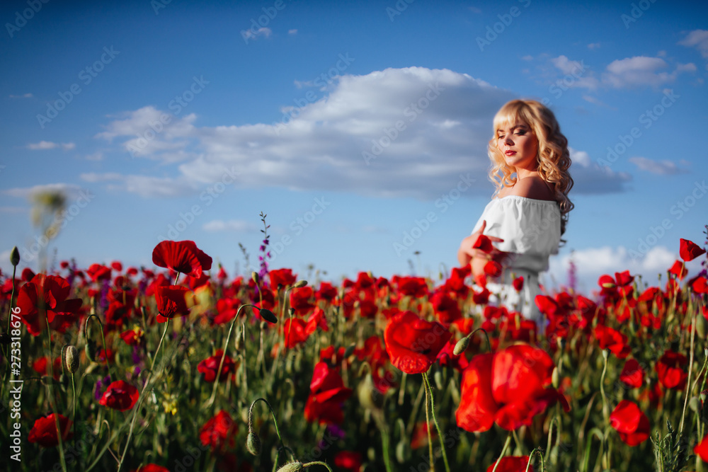 cheerful girl with curly blond hair in a huge poppy field alone, springtime, sunset cheerful girl with curly blond hair in a huge poppy field alone, springtime, sunset