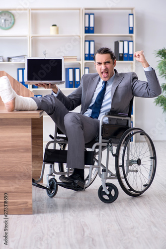 Male employee in wheel-chair in the office  © Elnur