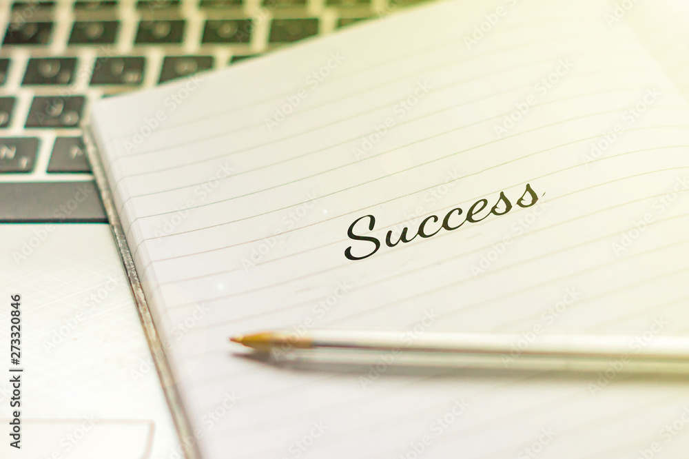 Writing note showing Success. Inspirational motivating quote on notebook Writing note showing Success. Inspirational motivating quote on notebook