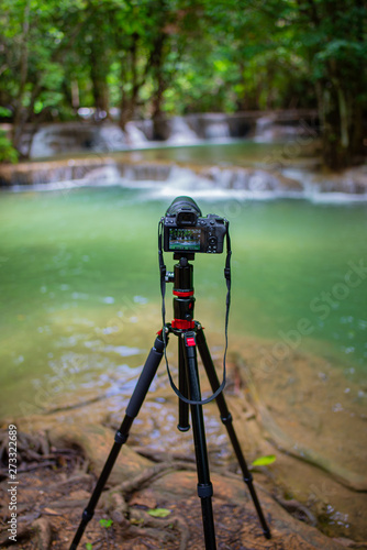 Digital camera on a tripod at waterfall