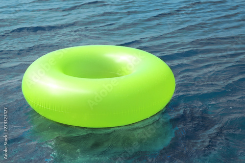 Bright inflatable ring floating on sea water. Summer vacation