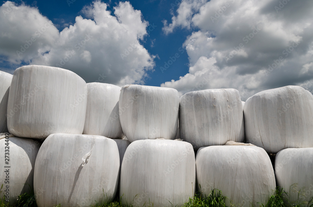 Garbage bales. Wrapped stacked bales round with white plastic film Garbage bales. Wrapped stacked bales round with white plastic film
