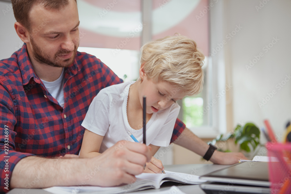 Obraz premium Preschool teacher helping his little student drawing, copy space. Adorable little girl enjoying drawing at class with her teacher