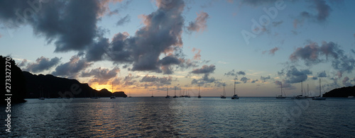 Sunset over Union Island with Sail boat yachts in the Tobago Cays near Saint Vincent and the Grenadines, Caribbean. photo