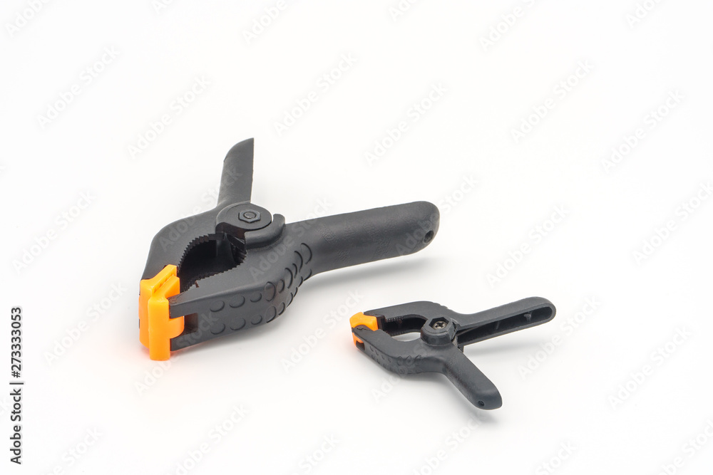 Black plastic clamps. Set of small and big size. Clamping equipment for handicraft, joinery and photography. White background. Black plastic clamps. Set of small and big size. Clamping equipment for handicraft, joinery and photography. White background.
