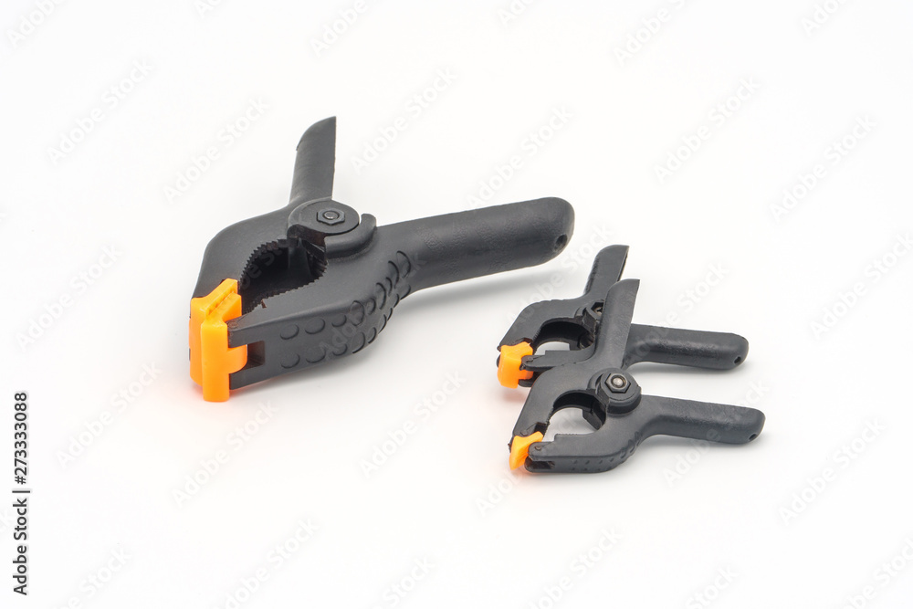 Black plastic clamps. Set of small and big size. Clamping equipment for handicraft, joinery and photography. White background. Black plastic clamps. Set of small and big size. Clamping equipment for handicraft, joinery and photography. White background.