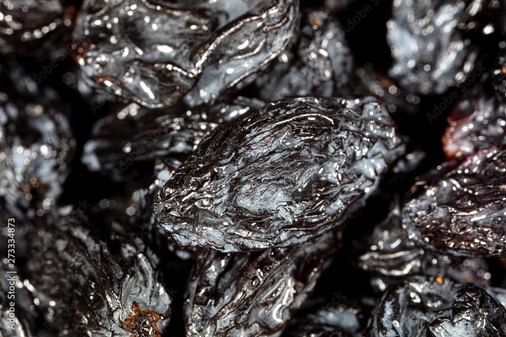 Black dry raisins as background