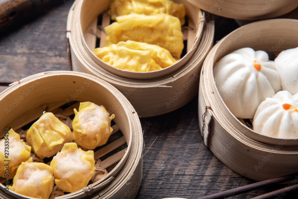 Dim sum on wooden table. Chinese food concept. Dim sum on wooden table. Chinese food concept.
