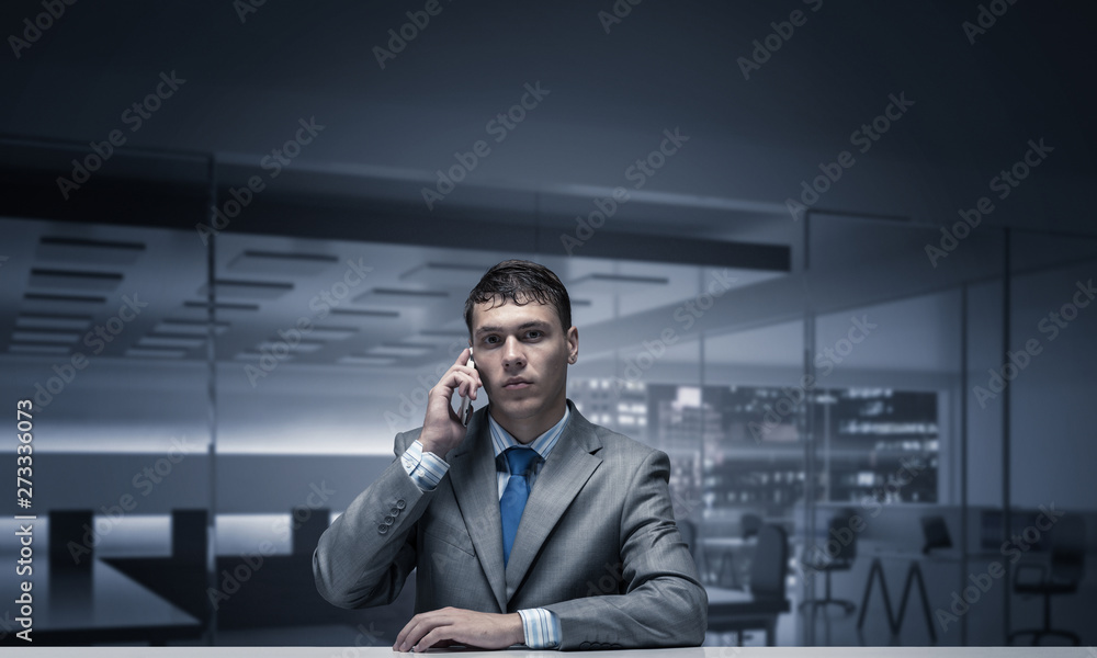 Young man talking on phone and looking at camera Young man talking on phone and looking at camera