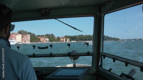On a ferry from venice to the island lido. Lots of those small ferry boats cross the channel to lido to transport tourists and commuters. the boats are like a subway for many people.