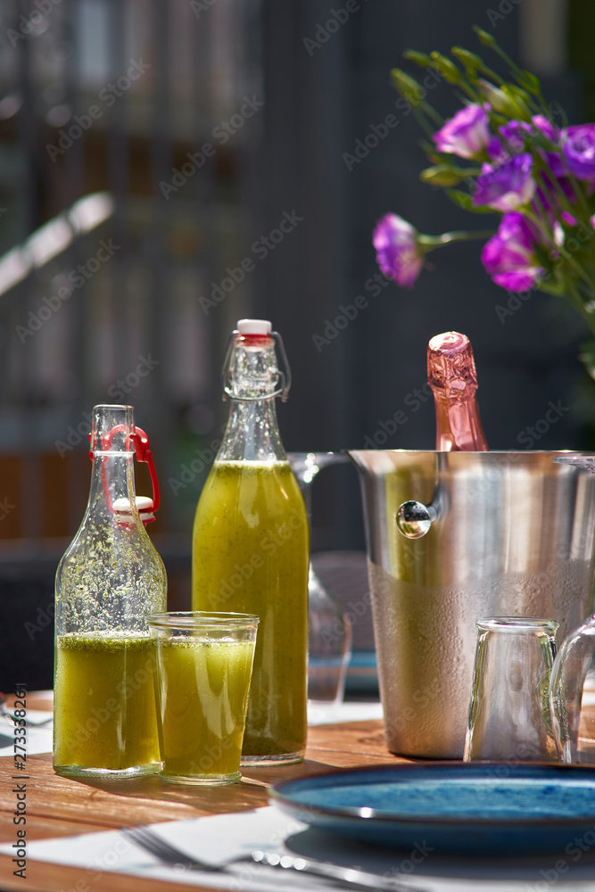 Green detox mashed potatoes with kiwi, spinach. drink in the bottle, as the background terrace restonan. Copy space, selective focus. Green detox mashed potatoes with kiwi, spinach. drink in the bottle, as the background terrace restonan. Copy space, selective focus.