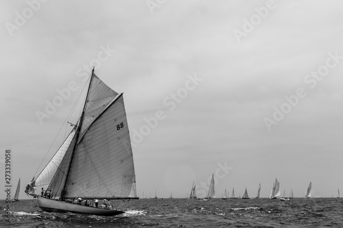 Vintage yachts race in Barcelona. Old ships and boats in the sea. Black and white photos of nautical sports in the ocean. Regatta in mediterranean sea. Sails, mast, sheet, canvas in the sky. Holidays