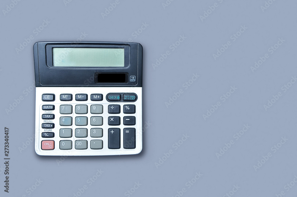 Flat lay or top view of calculator on viollet background paper with blank copy space, math, cost, tax or investment calculation. Tax reform Flat lay or top view of calculator on viollet background paper with blank copy space, math, cost, tax or investment calculation. Tax reform