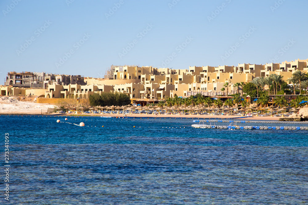 SHARM EL SHEIKH, EGYPT - March 18, 2019: Red Sea Coast, Concord Hotel. Beach with umbrellas, sun beds and palm trees. Background tourism and travel. Rest and vacation.