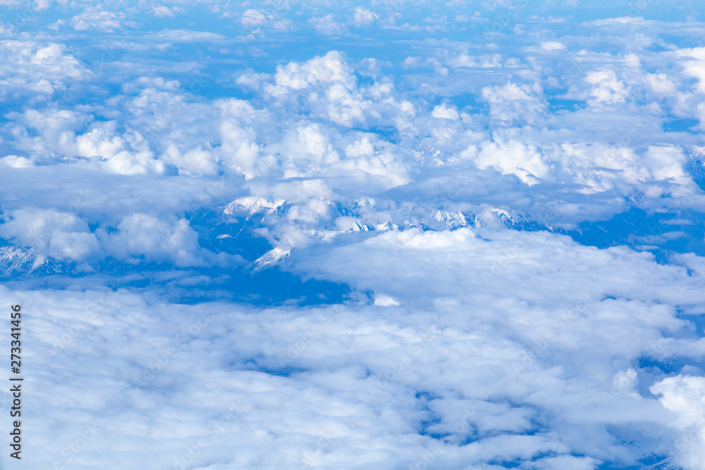 Aerial view of snowy high peaks of the Dolomites (mountain range, part of the Alps) in northeastern part of Italy peeping through clouds. Aerial view of snowy high peaks of the Dolomites (mountain range, part of the Alps) in northeastern part of Italy peeping through clouds.