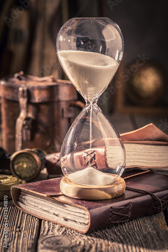 Hourglass and journal as a concept of travel memories