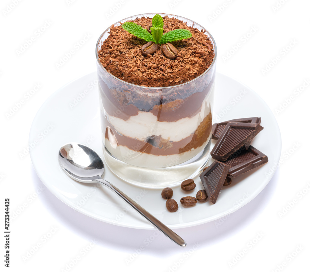 Classic tiramisu dessert in a glass on plate with spoon isolated on a white with clipping path Classic tiramisu dessert in a glass on plate with spoon isolated on a white with clipping path