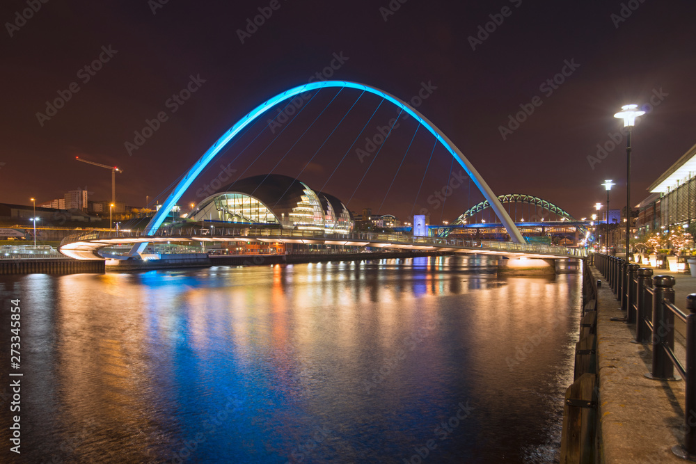 Newcastle and Gateshead quayside at night scene of River Tyne bridges and Sage