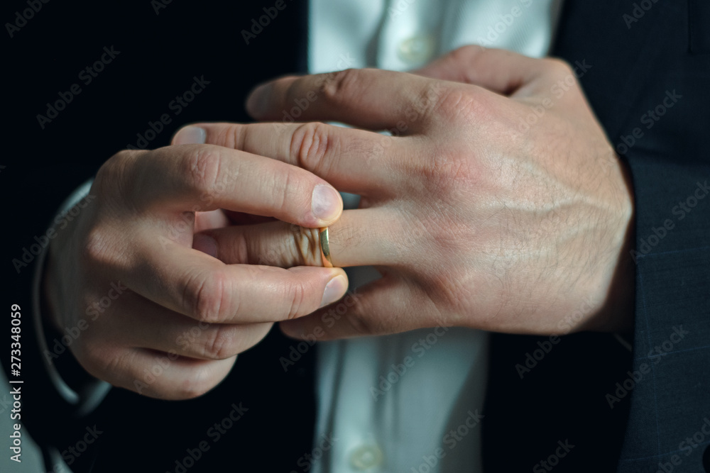 Business man taking off or putting on his wedding ring Business man taking off or putting on his wedding ring