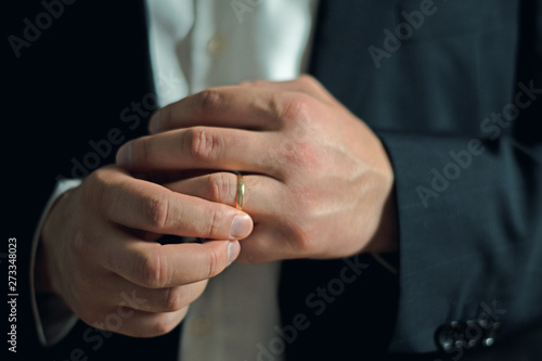 Business man taking off or putting on his wedding ring