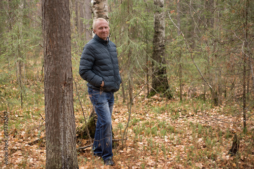 elderly man walking in the autumn forest